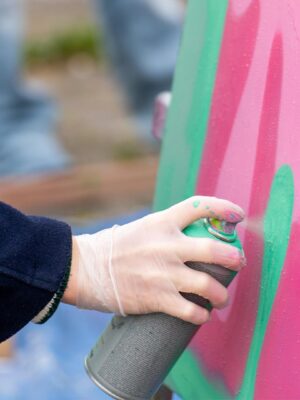 Deelnemer spuit graffiti op houten plaat tijdens Workshop Graffiti en tijdens het Graffiti Vrijgezellenfeest