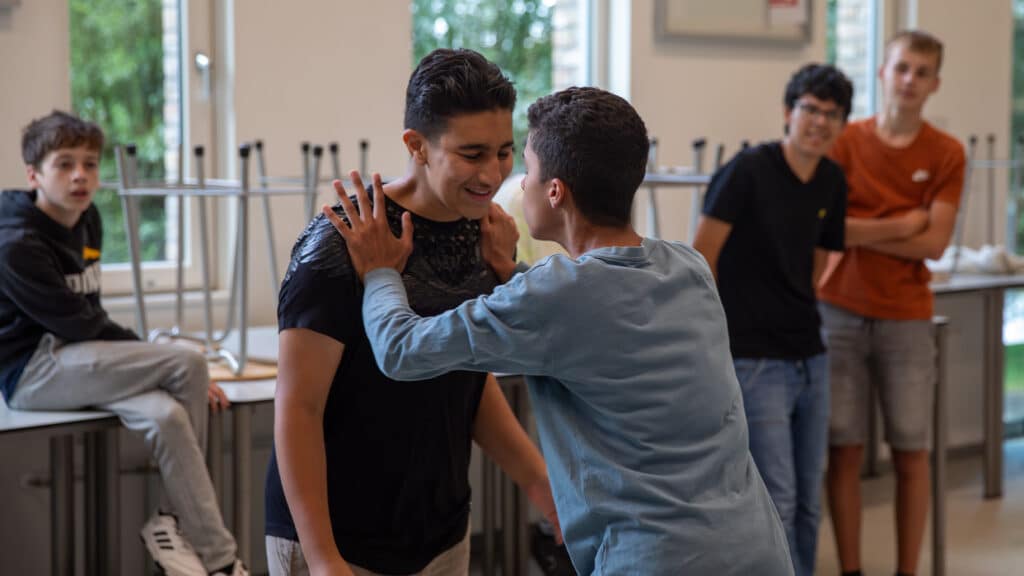 Deelnemers voeren een oefening uit van de Workshop Zelfverdediging.